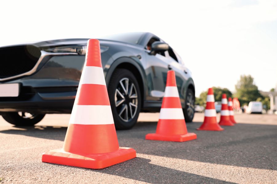 Instructor completing an evaluation form during a driving lesson